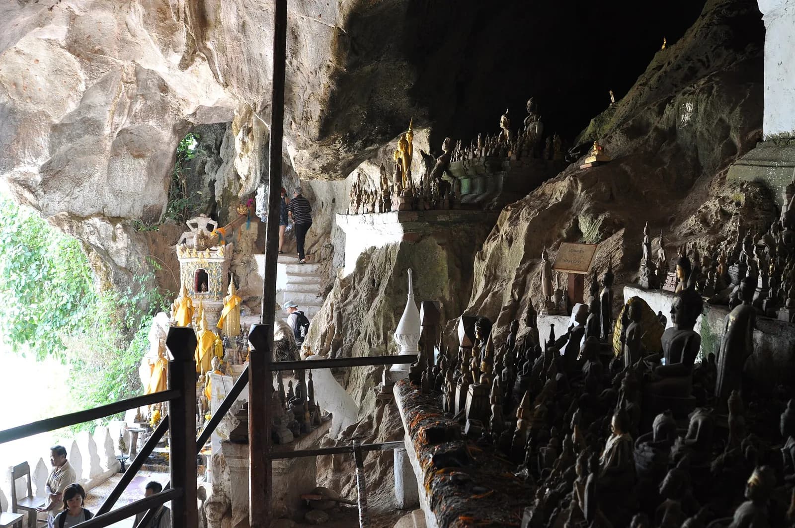 Buddha statues lining the rocky interior of the lower Pak Ou cave